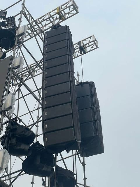 Cụm sub NEXO LS18 treo trên tháp truss cạnh dàn line array GEO S12 mười hai thùng tại sân khấu ngoài trời do BOS Entertainment dựng